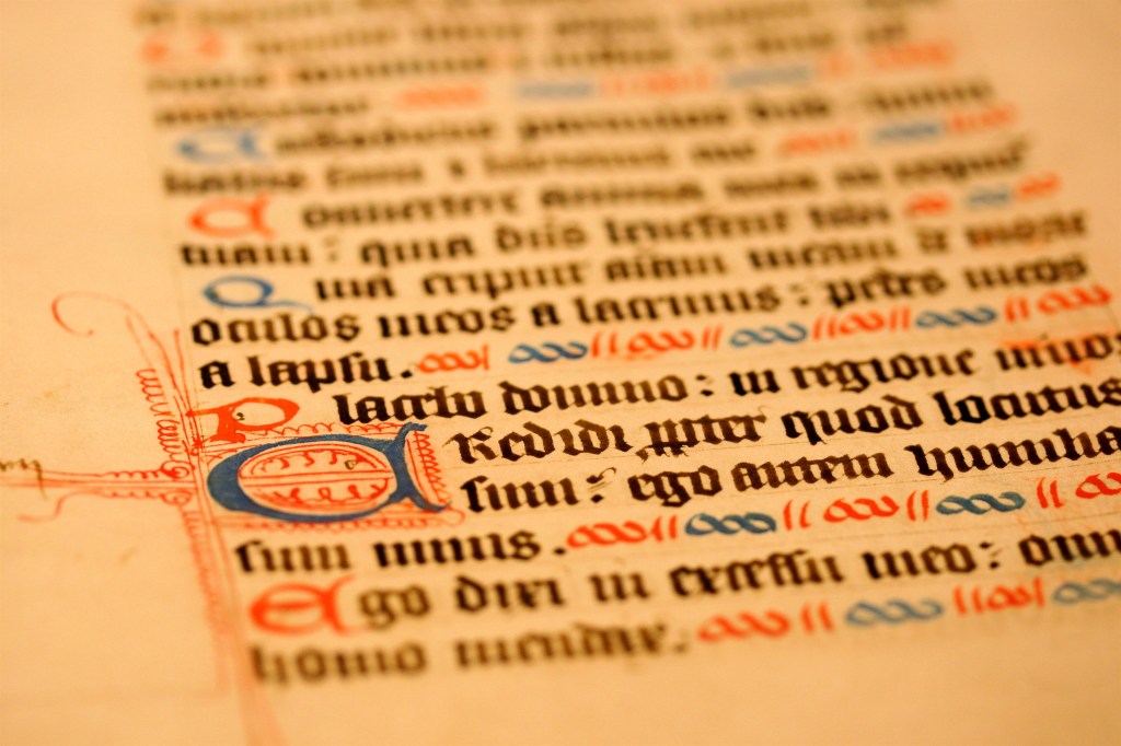 Close up photograph of handwritten, illuminated, calligraphic manuscript